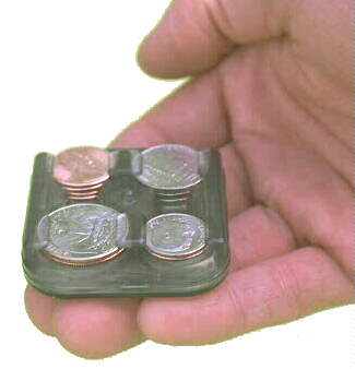 Hand holding loaded Chawly Changer coin dispenser